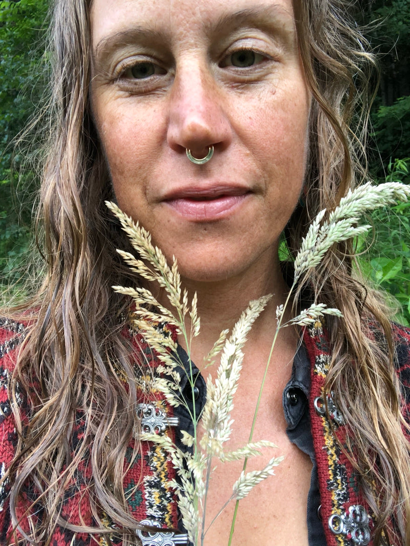 Sarah Stewart standing in front of one of her botanical murals